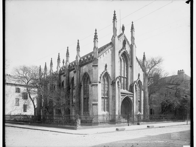 A large church with an iron fence. 