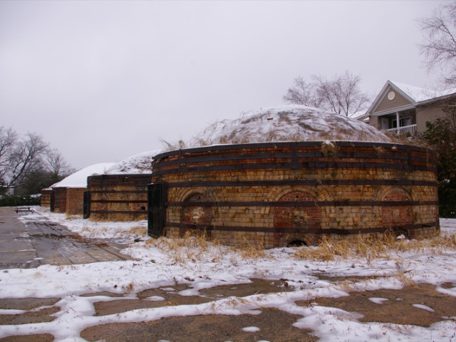 Round brick buildings covered in snow and ice. 