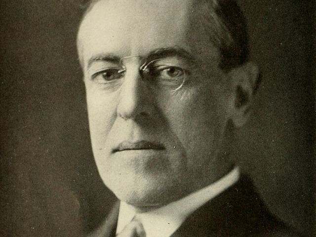 Stern looking Woodrow Wilson with thin framed glasses 