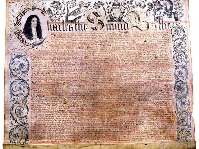 An old and yellowed document with illustrations framing the text and illustration of a man with long dark hair. 