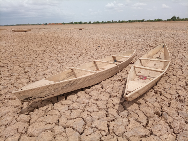Brown wooden boats on cracked earth during daytime