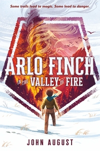 A boy stands in the snow in front of a hexagon of valley of burning trees.