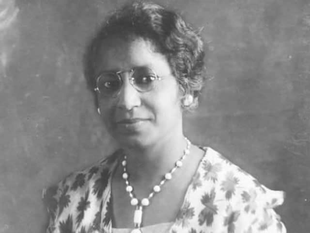Black and white photograph of Elise Forrest Harleston in glasses, necklace and dress.