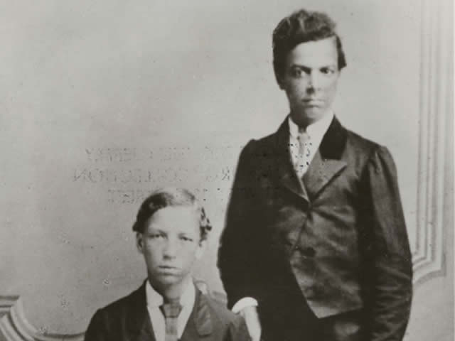 Archibald and Francis Grimkè as boys wearing suits for a photo.