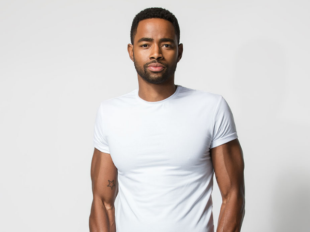 color photograph of Jay Ellis wearing a white tee shirt