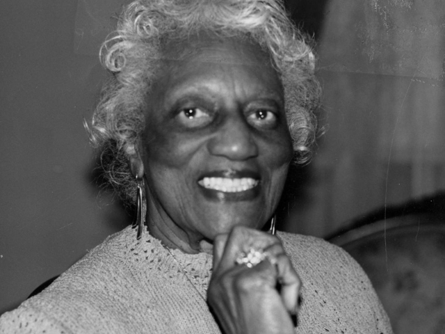 An older smiling Black Woman. 